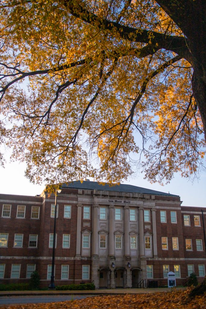 an exterior shot of ten Hoor Hall in the Fall and a tree with orange leaves